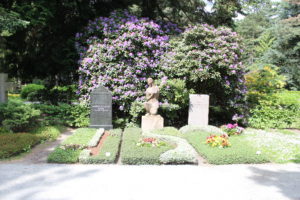 Gräber eingerahmt von Rhododendron